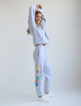 Person wearing sweatpants with colorful text on a white background