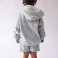 Child wearing a gray hoodie and shorts set with 'Elevated Faith' text on a white background