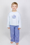 Child wearing a white long-sleeve shirt with custom applique and blue checkered pants on a white background